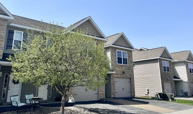 a tree in front of a house