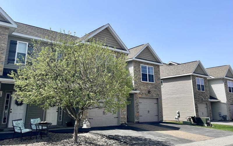 a tree in front of a house