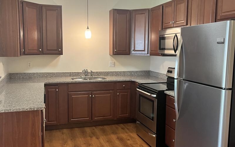a kitchen with wooden cabinets