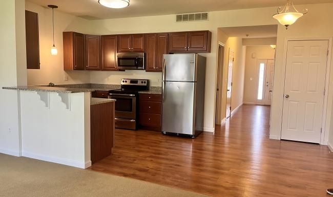 a kitchen with wooden cabinets